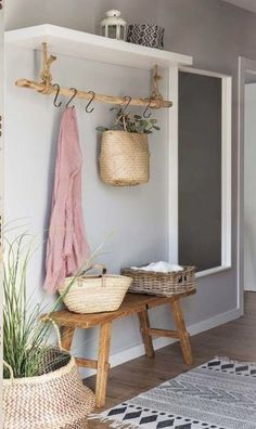 an entryway with baskets and plants on the bench next to it is featured in this post