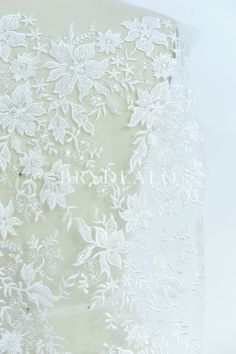 This beautiful designer lace fabric features delicate flower pattern embroidered on soft tulle base with beading and clear sequins adorned, which is perfect for making romantic wedding dresses. sold by the yard shown color light ivory content nylon, polyester, PET weight medium weight elasticity no width approx. 130cm washing instructions hand wash/drip dry Fitted Lace Tulle Fabric With Floral Embroidery, Fitted Lace Tulle Fabric With Floral Applique, White Tulle Lace With Floral Applique, White Floral Applique Tulle Lace, Romantic Wedding Dresses, Embroidered Lace Fabric, Light Ivory, Soft Tulle, Wedding Dresses Romantic