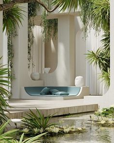 an outdoor bathtub surrounded by plants and water