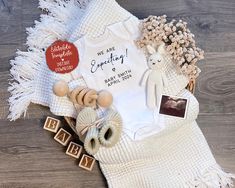 a baby's first birthday outfit and other items on a blanket