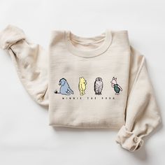 This cozy Winnie the Pooh sweatshirt is perfect for any Pooh Bear fan! The design features a playful illustration of Winnie the Pooh, Piglet, and Eeyore on a softfabric. Made from a blend of cotton and polyester, this sweatshirt is comfortable and durable. The long sleeves and ribbed cuffs and hem provide a snug fit, making it perfect for a chilly day. The sweatshirt is unisex, perfect for anyone and any age. Whether you're lounging at home or running errands, this sweatshirt is sure to bring a Sweatshirt And Shirt Outfit, Vintage Pooh Bear, Winnie The Pooh Party, Vintage Pooh, Family Sweater, Pooh Party, Classic Winnie The Pooh, Pet Sweater, Halloween Embroidery