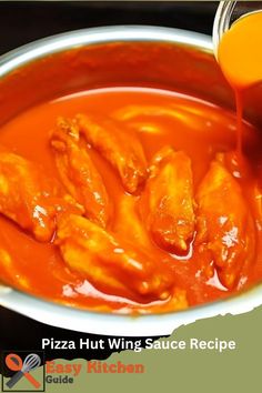 a person pouring sauce into a bowl filled with chicken wings