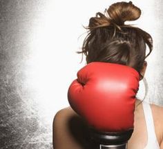 a woman with a red boxing glove on her head