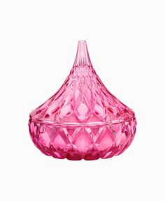 a pink glass vase sitting on top of a table