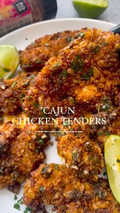 cajun chicken tenders on a plate with avocado and lime wedges