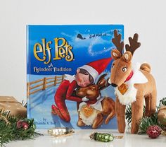 an elf and his reindeer are posed in front of a book cover for elf pets