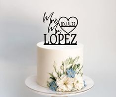 a wedding cake topper that says we are mr and mrs lopez on it