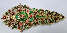 A beautiful Vintage turban pin or Pendant from Rajasthan, encrusted with old mine cut Diamonds, Rubies, Emeralds set in 20 carats solid Gold and back adorned with multicolor enamel exquisite work, Detailed Kundan Meen work an Original classic collector's piece which could be easily adopted into two individual pendants or Brooch and a pendant. very versatile piece in good condition. Size of piece-11/4.5 cm, total weight-54 grams(2.94). Material-solid 20 carat gold and natural genuine Gemstones. Traditional Wedding Brooch Jewelry, Traditional Ceremonial Brooch Jewelry, Traditional Green Brooch Jewelry, Mughal Jewelry, Pin Pendant, Gold Diamond, Turquoise Bracelet, Ruby, Emerald