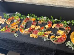 a table topped with lots of different types of fruits and veggies next to the number 50