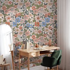 a desk and chair in front of a floral wallpaper