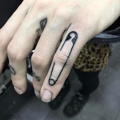 a person with a tattoo on their left hand