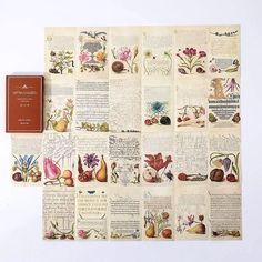 an old book is sitting on top of a piece of paper with flowers and plants