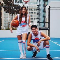 a man and woman posing for a photo on a basketball court