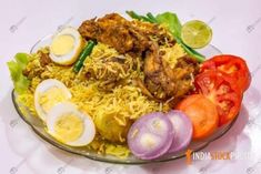 a plate filled with rice, meat and vegetables