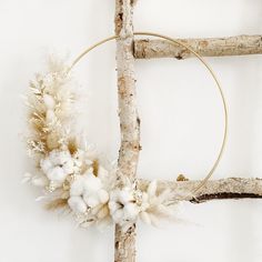 a wreath made out of branches and cotton