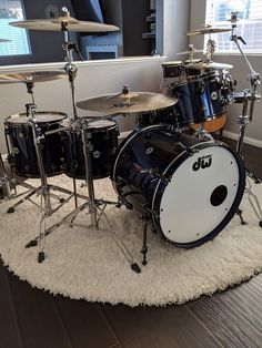 a drum set sitting on top of a white rug