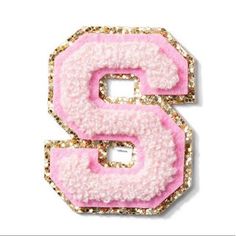 the letter s is made up of pink and gold glittered fabric with sequins