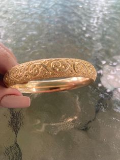 Hello, this listing is for a beautiful Antique deeply etched gold filled hinged bangle bracelet. It is in very nice condition for the age there is only one slight dent on the outside right where the hinge opens as shown in the picture. The bracelet closes nice and tight. It measures on the inside diameter across 2 1/2" and measures 7 and 1/8" on the inside circumference. It weighs 26.6 grams and is 1/2" wide. it is marked inside A.A.G.  1/10. Please check out the pictures as they are the best de 14k Gold Hinged Bangle For Anniversary, Classic Gold Etched Bangle, Heirloom Gold Hinged Bracelets, Heirloom Gold Hinged Bracelet, 14k Gold Bangle With Intricate Design For Anniversary, Wedding Gold Hinged Bracelet, Gold Hinged Bracelet For Weddings, Anniversary 14k Gold Bangle With Intricate Design, Gold Etched Bracelet For Wedding