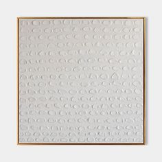 a white wall with circles on it and a gold frame around the edges, in front of a gray background