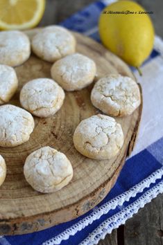 lemon cookies are arranged on a wooden plate