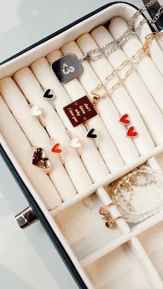 an open jewelry box filled with lots of different types of necklaces and rings in it