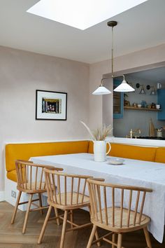 a dining room table with four chairs around it