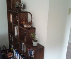 a book shelf filled with books next to a wall mounted planter on top of it