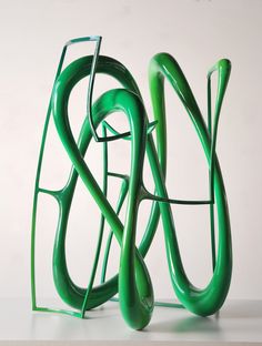 a green sculpture sitting on top of a white table