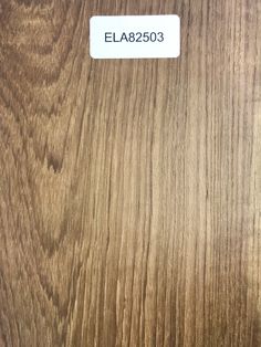 a close up of a wooden surface with a label on it that says ela2503