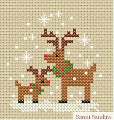 a cross stitch pattern with two reindeers in the snow