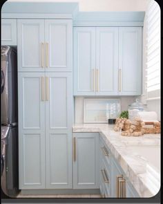 a kitchen with blue cabinets and white counter tops