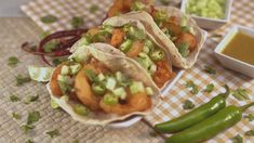 three tacos and some green beans on a table