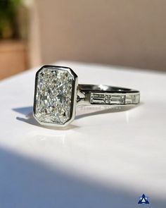 a diamond ring sitting on top of a white table