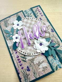 a close up of a greeting card with flowers and the word hello written on it