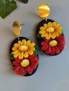 the earrings are decorated with colorful flowers