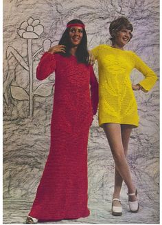 two women standing next to each other in knitted dresses and head scarves,