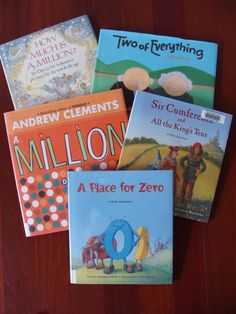 four children's books are sitting on a wooden table with the title, a place for zero