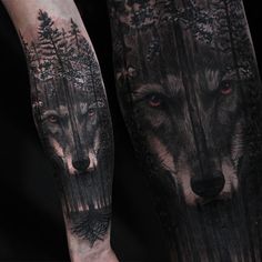 two wolfs with red eyes and trees on their legs are shown in this tattoo design