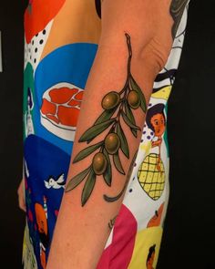 an olive branch tattoo on the arm