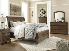 a bedroom scene with focus on the bed and dresser