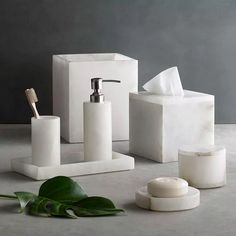 white bathroom accessories including soap dispenser and toothbrush