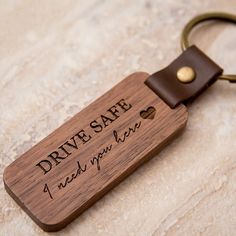 a wooden keychain that says drive safe and i need you here