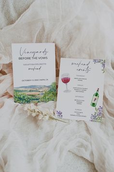 the wedding stationery is laid out next to each other on a bed with white ruffled sheets