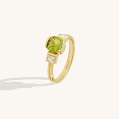 Art Deco Peridot Ring in 14K solid gold, featuring a captivating cushion-cut lab-grown peridot gemstone. Elevate your style with vintage charm. Free shipping. Luxury Yellow Gold Peridot Rings, Luxury Peridot Rings With Accent Stones, Yellow Gold Peridot Rings With Gemstone Accents, Classic Peridot Gemstone Diamond Ring, Classic Peridot Diamond Ring, Luxury Green Cushion Cut Diamond Ring, Elegant Peridot Diamond Ring, Elegant Lime Green Ring With Center Stone, Elegant Lime Green Gemstone Rings