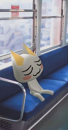 an animated cat is sitting on a train seat