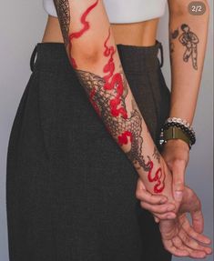 two people holding hands with tattoos on their arms and the words love are painted on them