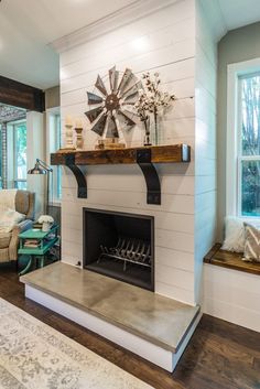 a living room with a fire place next to a window and a tv on the wall