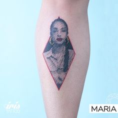 a woman's leg with a tattoo on it that has an image of a woman