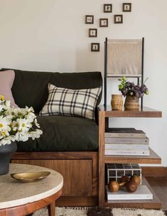 a living room filled with lots of furniture and flowers on top of a coffee table