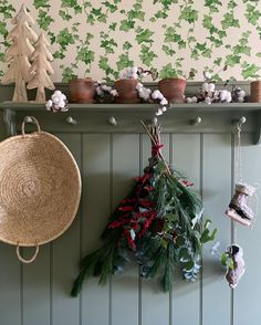 a shelf with christmas decorations and plants on it